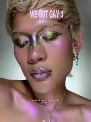 What's your favorite part of @august’s look? 💫 💖 #KaleidosEyeliner in Aurora Runner + Jackpot Jinx 💖 #SpaceAgeHighlighter in Gifted 💖 #GlassloadLipMelt in Cheat Code #pridemakeup #colorfulmakeup 