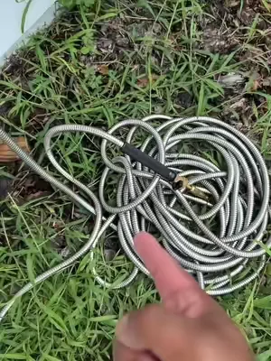 Stainless Steel Garden Hose is great for dragging and tugging without puncturing and can support all weather. Comes with brass fittings and even comes with its own nozzle! #gardening #gardenhose #garden #hose #homeessentials 