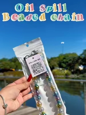The Oil Spill Beaded Chain catches the light and brings the perfect pop of color ✨ Add it to your favorite bag or attach it to your phone case for a fun, colorful upgrade. 🌈📱 #IrisAndRainbow #tiktokmademebuyit #TikTokShop #irisarmy 