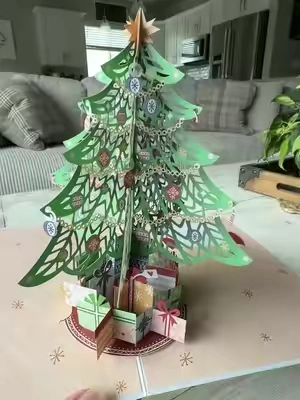 Not your ordinary Christmas card! 🎄✨ This 3D pop-up Christmas tree card turns into a little holiday decoration they can display long after they open it. #ChristmasCards #PopUpCard #3DChristmasCard #ChristmasGifts #HolidayDecor