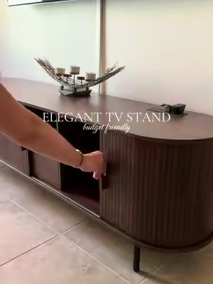 The prettiest way to hide all the living room clutter 🤭 This fluted TV stand has so much hidden storage and instantly makes the space look more elevated. 🤎✨ #tvstand #flutedtvstand #budgetfriendly #homefinds #tiktokshopstockup 