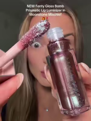 NEW Fenty Gloss Bomb Prismatic Lip Luminizer in Moonstone Mischief just launched! This is a limited-edition holiday shade with a shimmery holographic plum-brown base! Omg this is so beautiful!!  @Fenty Beauty  #FentyGlossBombPrismatic #FentyMoonstoneMischief #FentyHoliday2026 #PrismaticGloss 